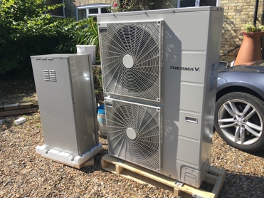 An Air Source heat pump located in someone's garden