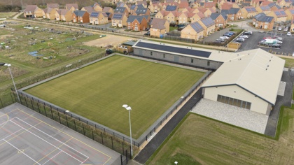 An aerial drone shot of the new Northstowe sports pavilion and bowling green. There are allotments and new houses around the site. Image: davidjohnsonphotographic.co.uk