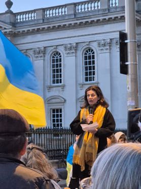 Cllr Bridget Smith speaking to a crowd outside the Senate House in central Cambridge