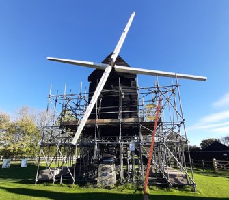 Bourn Mill with scaffolding around the edge.